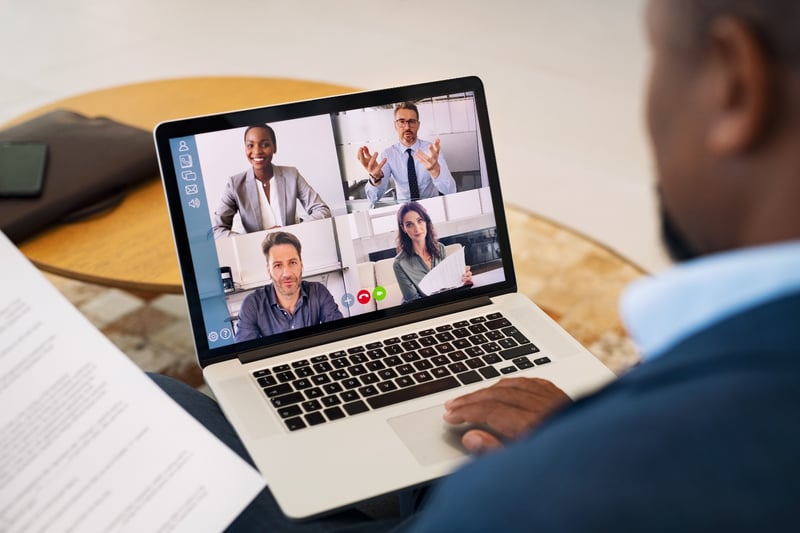 The Entrust Group. Employees working together via a remote call.