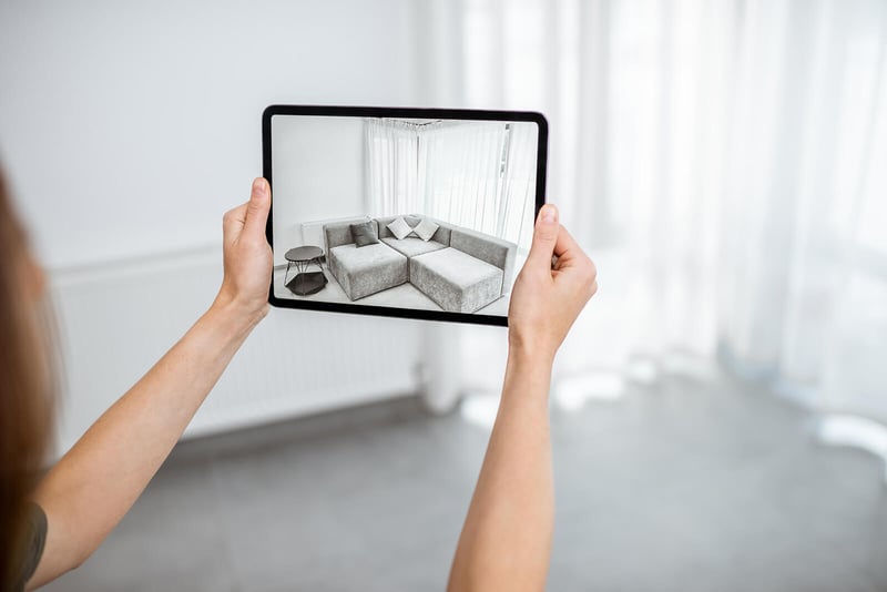 The Entrust Group. Woman uses augmented reality to envision her living room arrangement.