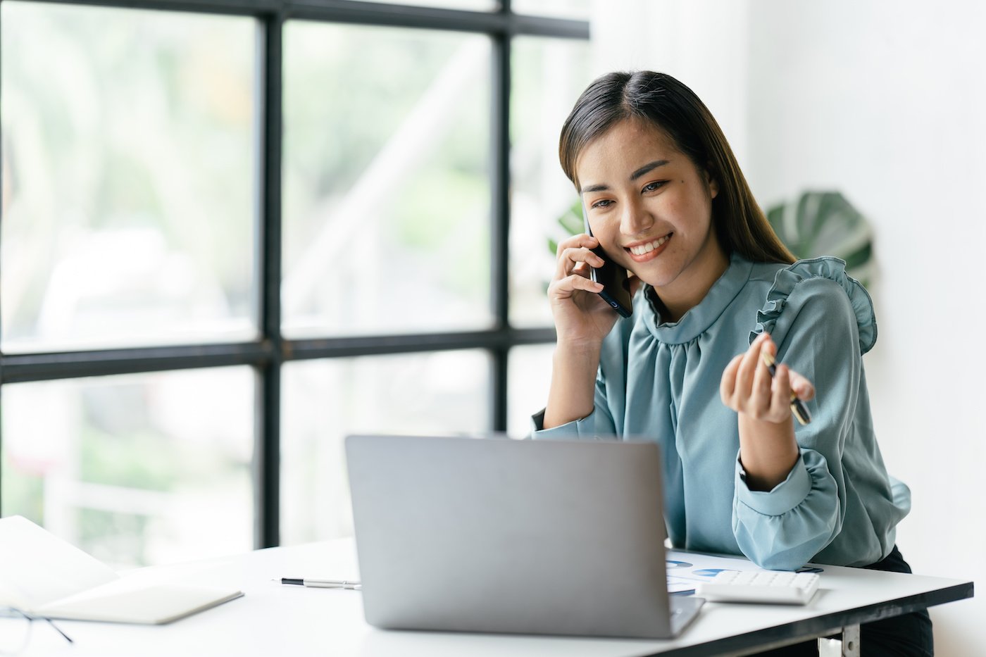 woman on phone at her desk