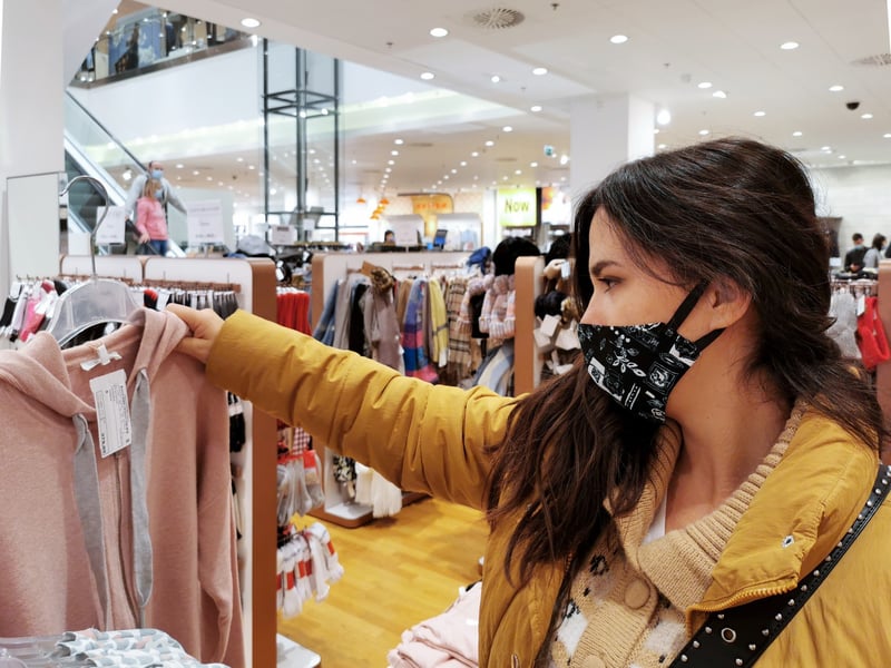 The Entrust Group. Young woman wear a mask and shopping in mall.